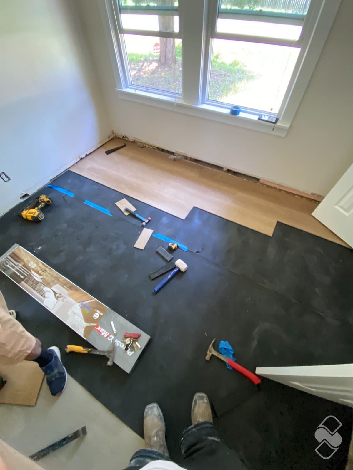New luxury vinyl plank flooring being installed over a prepared subfloor