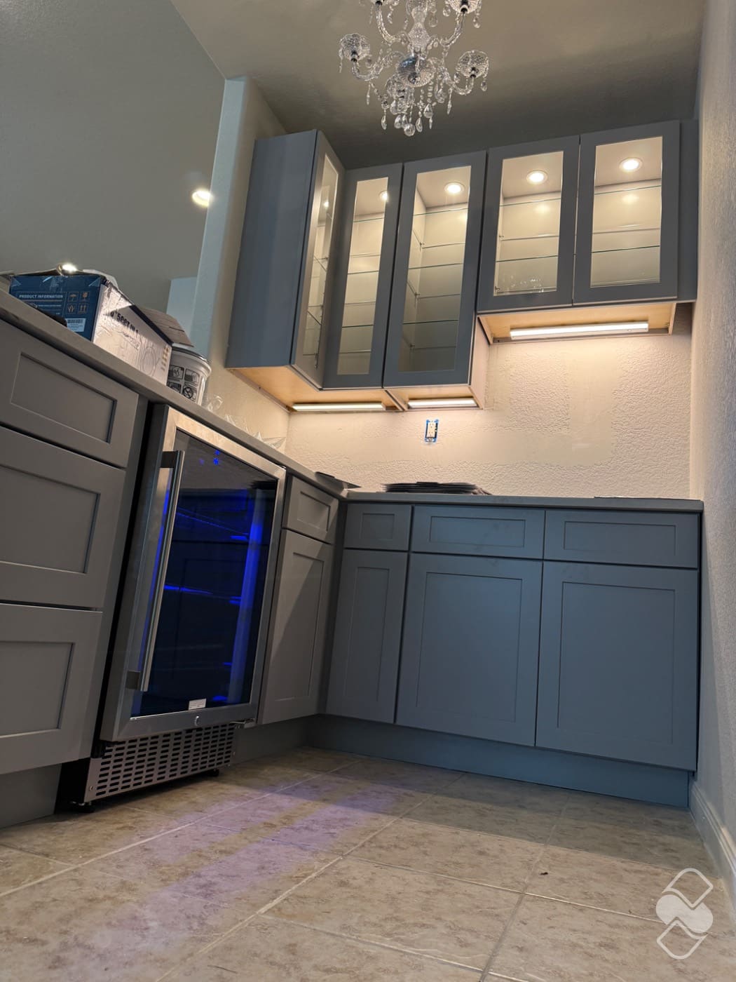 Built-in beverage center with cabinetry set level and lit inside a remodeled coffee bar nook