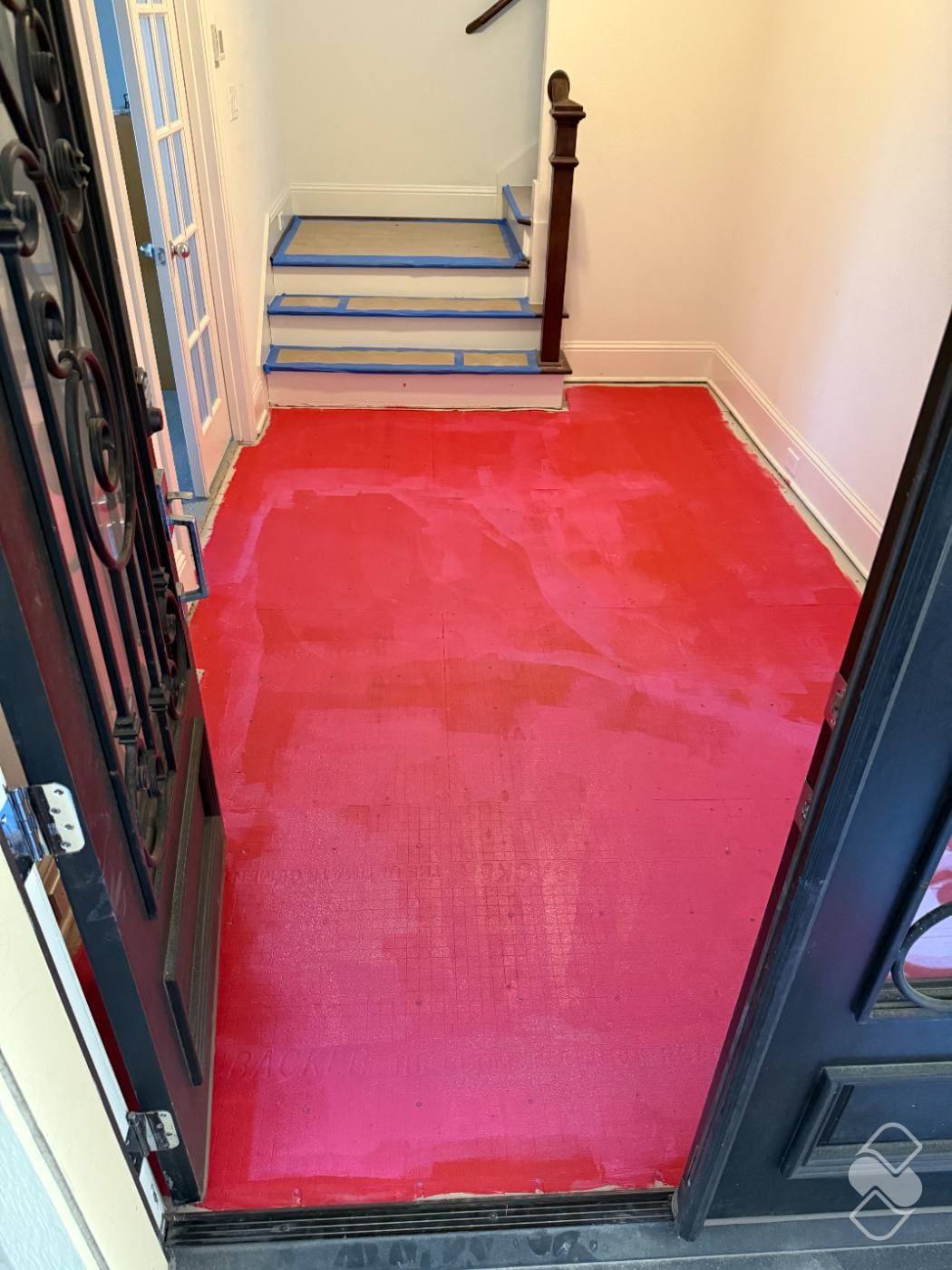 Waterproofing membrane applied across a shower floor and up the walls before any tile goes on